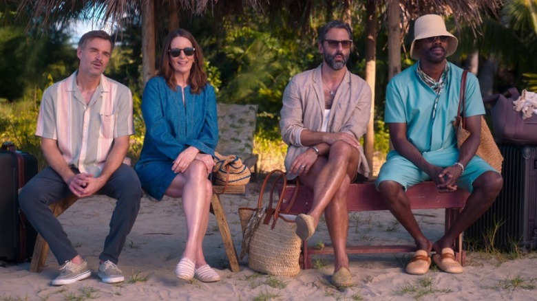 Jack (Will Forte), Kate (Tina Fey), Claude (Marco Calvani), and Danny (Colman Domingo) sitting together on benches on the beach on The Four Seasons S1E3