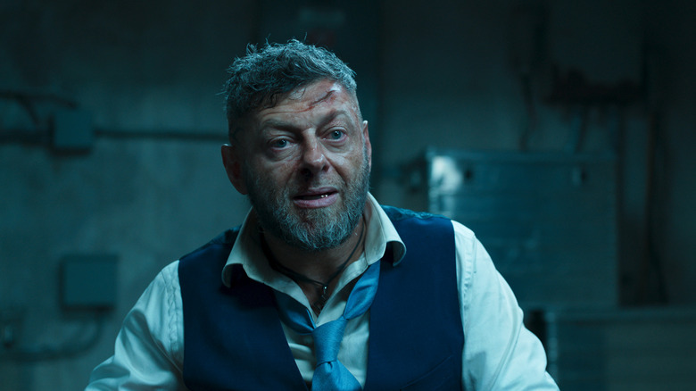 Andy Serkis as Klaue sitting in an interrogation room in Black Panther