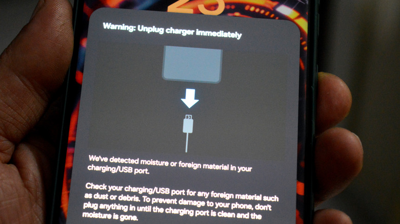 A display of the warning to unplug phone with moisture or foreign material detected in port