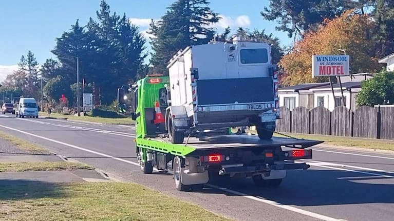 The speed camera trailer unit being taken away.
