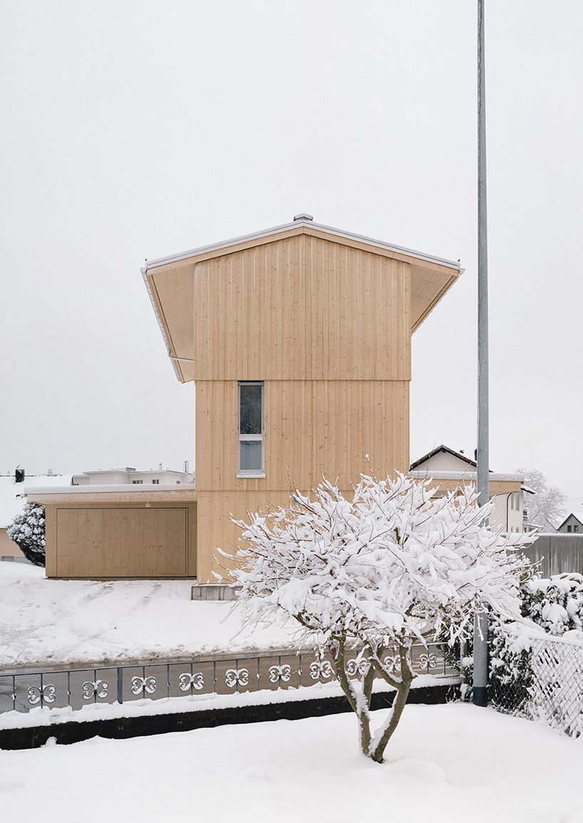 the tower house explores vertical living through prefabricated timber design 4