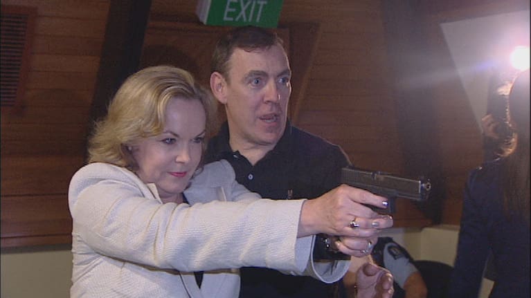 Then-police minister Judith Collins holds up a gun in 2011 at a media even.