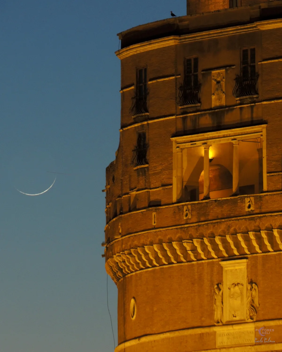 A beautiful thin crescent Moon, one day old, setting beside the Loggia of Julius II at Castel Sant'Angelo, Rome, Italy, captured by Paolo Palma, 17 May 2026