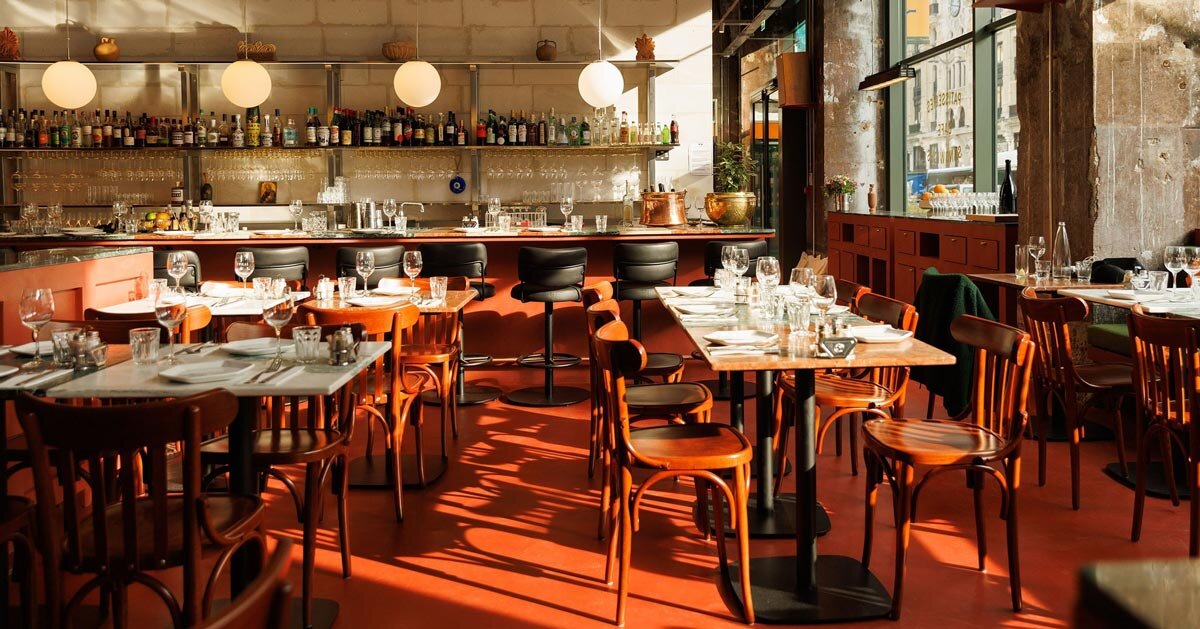 red floor anchors parisian restaurant ypseli with steel and marble textures