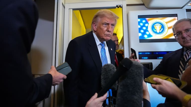 US President Donald Trump speaks to reporters aboard Air Force One, Friday, May 15, 2026, as he returns from a trip to Beijing, China.