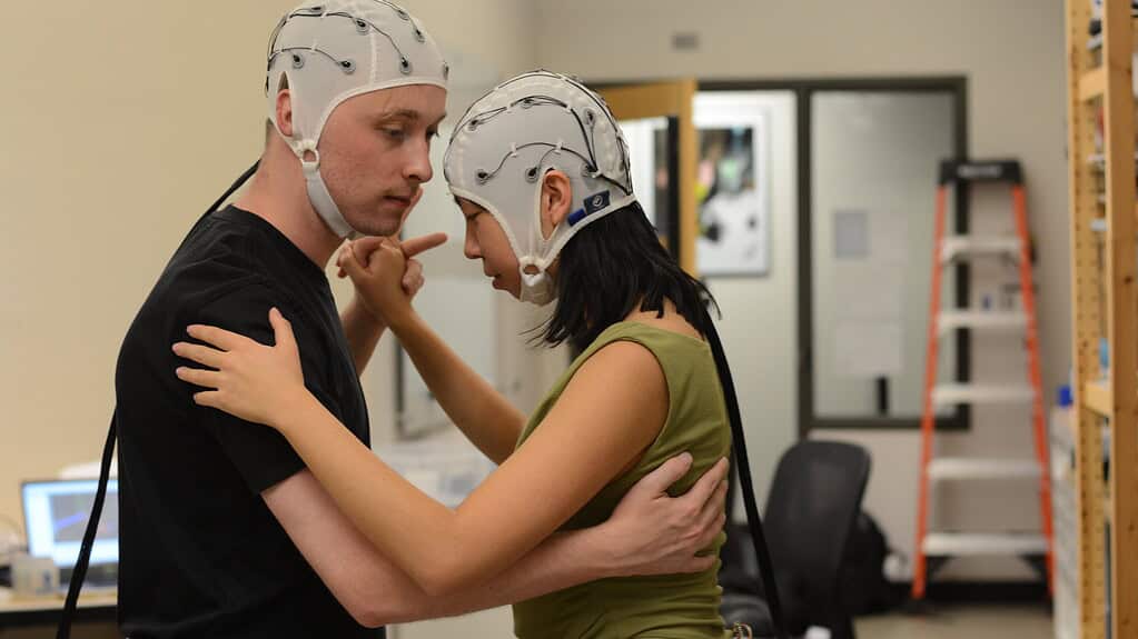 Two tango dancers wearing EEG caps to measure how synchronised their brain patterns are