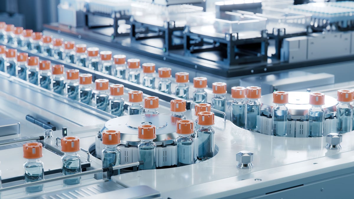 Vaccine vials on a conveyor belt.