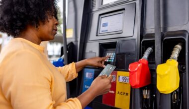 Person paying for gas with credit card at pump.