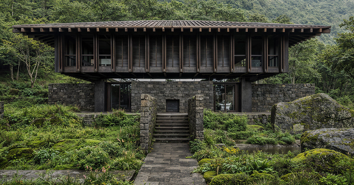 V taller proposes forest retreat around monolithic stone core for NOT A HOTEL in japan