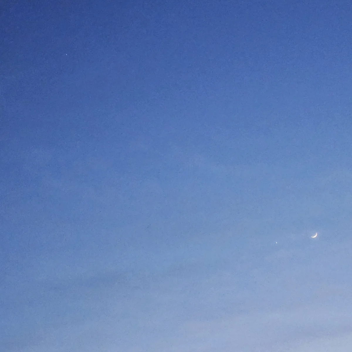 Thanks to Britt Noel for sending us this image of Venus and the crescent Moon (right, below centre) and Jupiter (top left), captured from Essex, Maryland, USA, 18 May 2026 around 20:40 local time.