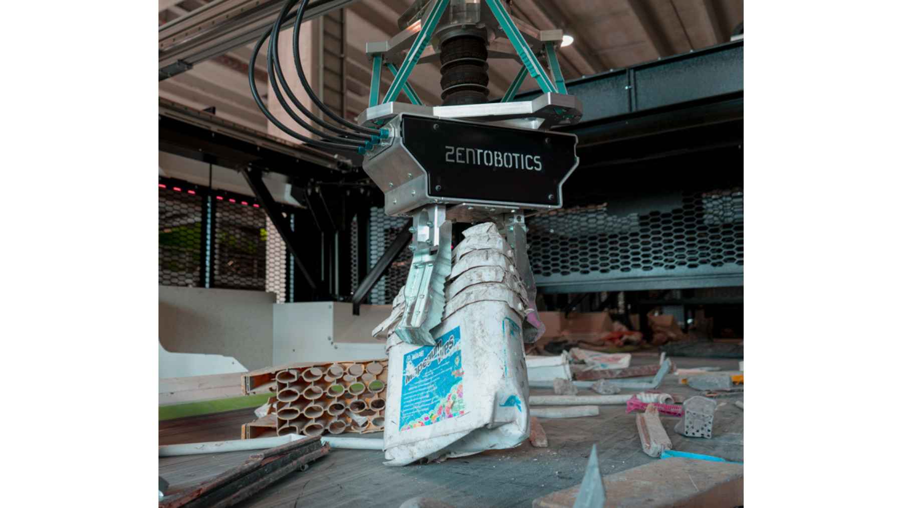 Industrial robotic arm sorting plastic waste in a recycling facility