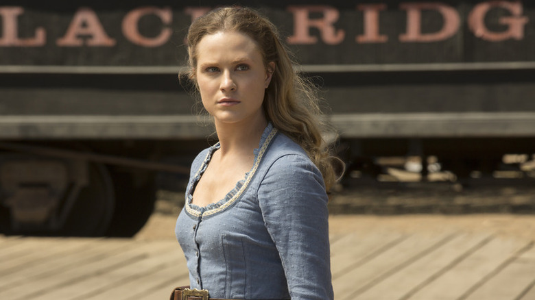 Dolores Abernathy stands at a train station