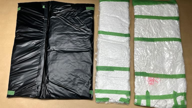 When officers removed the contents of each suitcase, X-rays allegedly revealed inconsistencies.