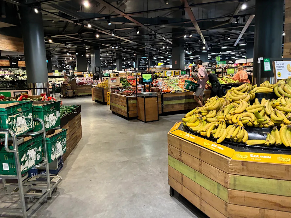 The produce section of the Woolworths store shows fruit and vegetables wrapped in soft plastic.