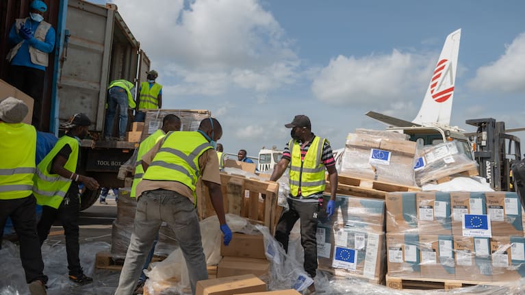 Workers offload medical and emergency supplies donated by European Union to support frontline workers in fighting Ebola upon arrival at the national airport in Bunia, Congo