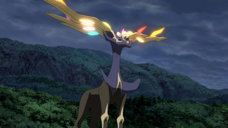 Xerneas standing in a forest with glowing horns in Pokemon the Movie: Diancie and the Cocoon of Destruction