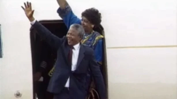 Nelson Mandela and wife Winnie waving from an aeroplane