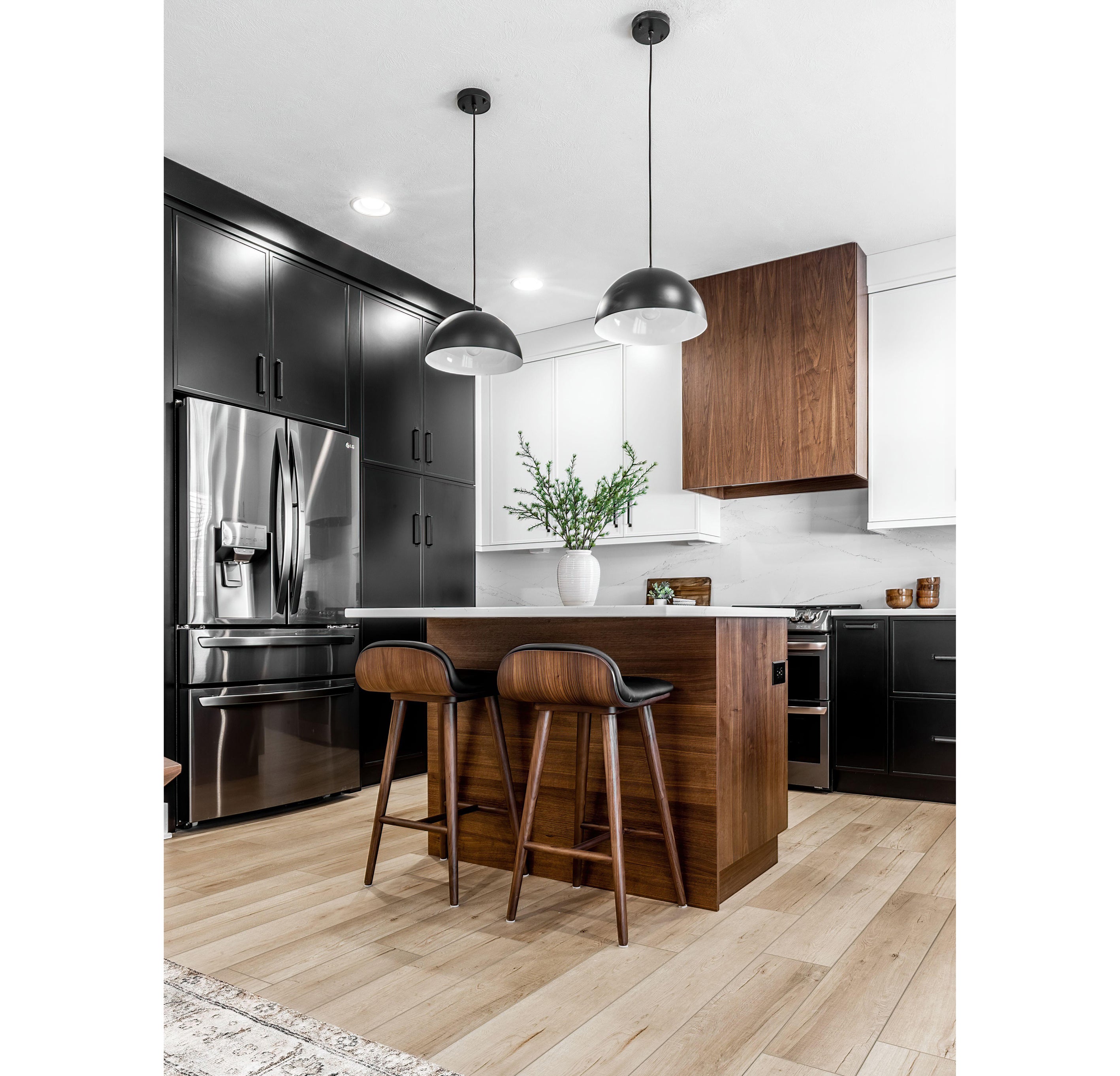 Midcentury modern kitchen and dining room interior design with black cabinets, white cabinets, white quartz and walnut accents (Alamy/PA)