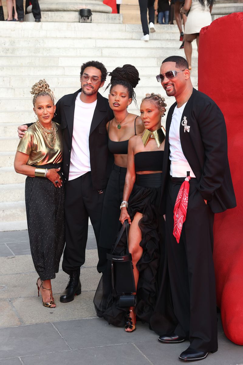Will Smith and Jada Pinkett Smith pose in coordinated looks with Willow and Trey Smith to support Jaden Smith at Paris Fashion Week