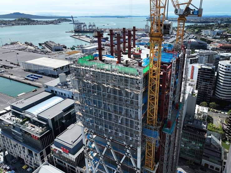 Work on the Seascape apartment tower, left, in Auckland’s CBD stopped in 2024. The tower and other properties owned by developer Shundi Customs are being sold by the receivers. Photo / Michael Craig