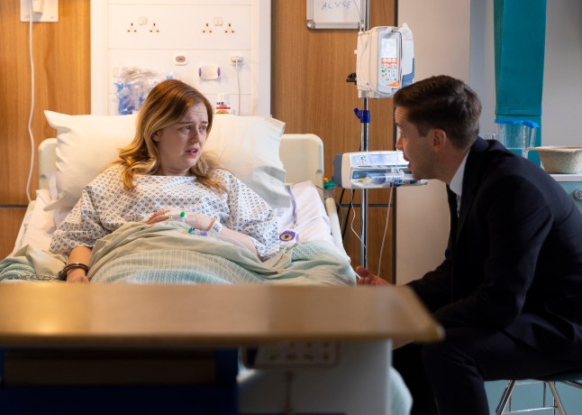 Todd comforts Summer, who is laying in a hospital bed in Corrie
