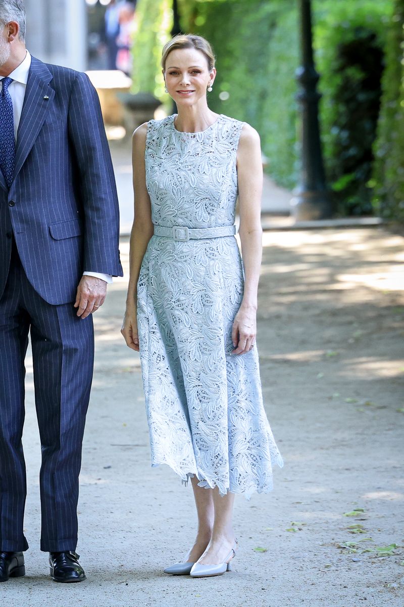 Charlene completed her romantic ensemble with pearl earrings, a diamond ring, and classic slingback pumps.