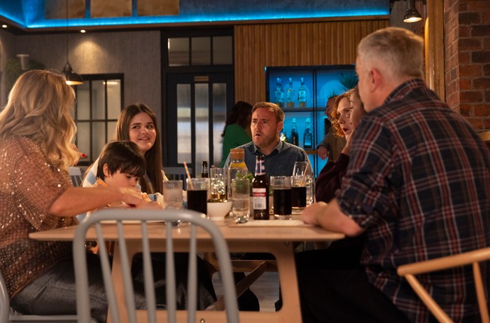 The Dobbs family and Steve look shocked as Hope smiles in a scene from Coronation Street