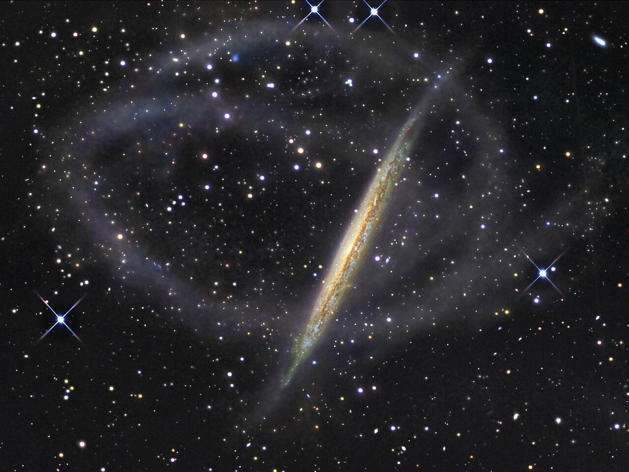 NGC 5907, some 50 million light years away, wrapped in vast loops of stars, the shredded remains of a smaller galaxy it consumed billions of years ago. Arrakihs will hunt for streams like these around at least 80 Milky Way-sized galaxies (Credit : R. Jay GaBany)