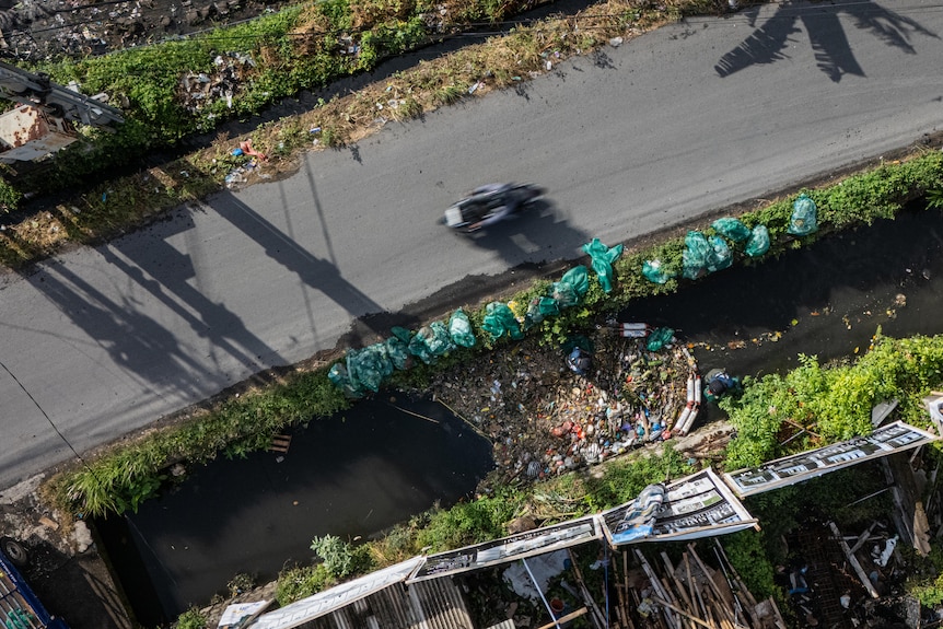 A birdseye view of trash piled up in a waterway in Bali's Denpasar.