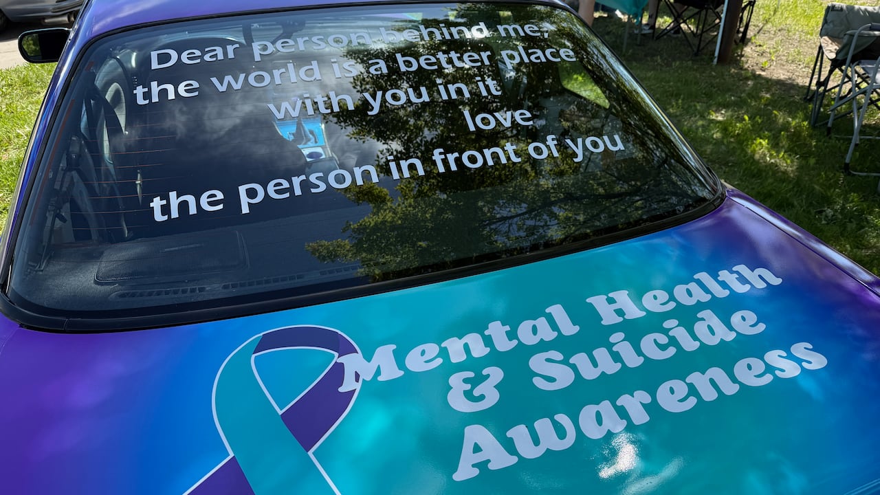 In addition to the bright teal and purple colours, the car is wrapped in positive messages, front, side and back, reminding the community there is help for anyone struggling with mental health.