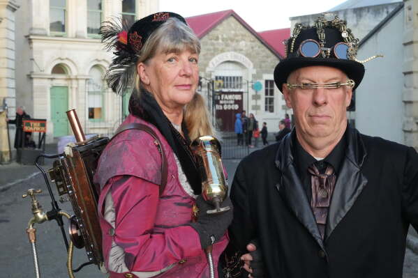 Steampunk NZ Festival attendees Juliet Thorn and Greg Thorn, dressed as their steampunk personas Lady Sarsaparilla Ovabyte and Captain Bob McSpoon, pose for a portrait during the annual event in Ōamaru, New Zealand, on May 29, 2026. (AP Photo/Charlotte Graham-McLay)
