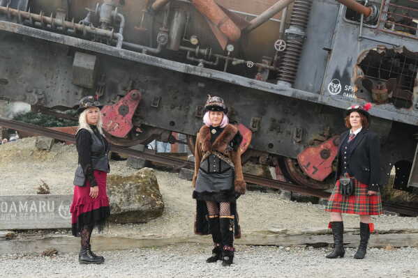 Steampunk NZ Festival attendees Fiona Hilton, left, Sandy Jones and Priscilla Martin, right, pose for a portrait during the annual event in Ōamaru, New Zealand, on May 30, 2026. (AP Photo/Charlotte Graham-McLay)