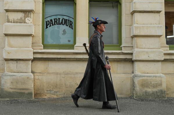 An attendee at the Steampunk NZ Festival walks through the Victorian precinct in Ōamaru, New Zealand, Sunday, May 31, 2026. (AP Photo/Charlotte Graham-McLay)