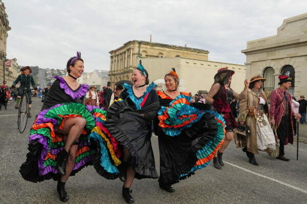 Participants walk in a parade at the Steampunk NZ Festival in Ōamaru, New Zealand, Saturday, May 30, 2026. (AP Photo/Charlotte Graham-McLay)