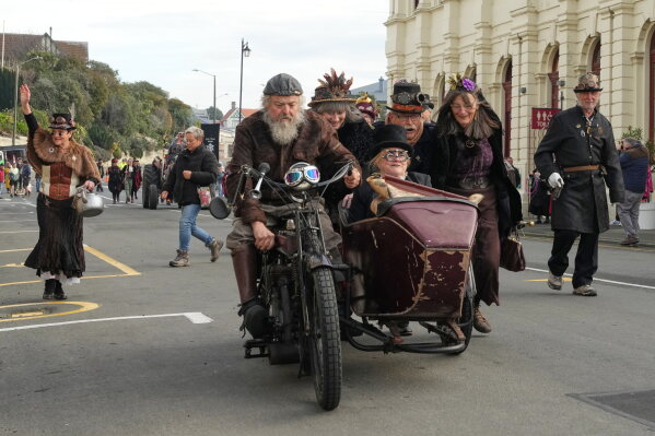 Attendees participate in a parade at the Steampunk NZ Festival in Ōamaru, New Zealand, Saturday, May 30, 2026. (AP Photo/Charlotte Graham-McLay)