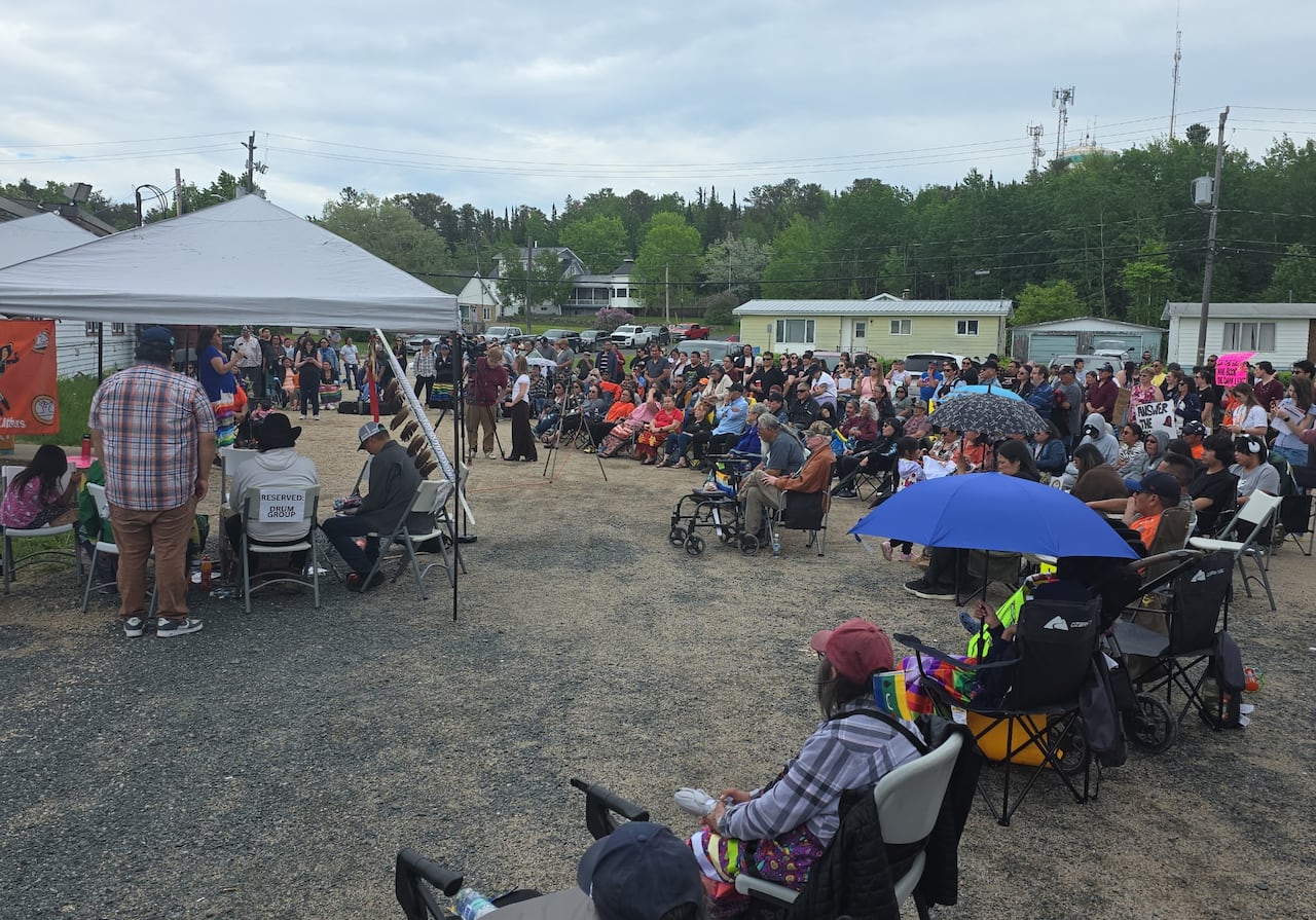 A large crowd of people is seen gathered outside.