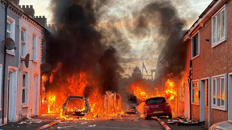 Vehicles set on fire by protesters burn on Lendrick Street in east Belfast, Northern Ireland.