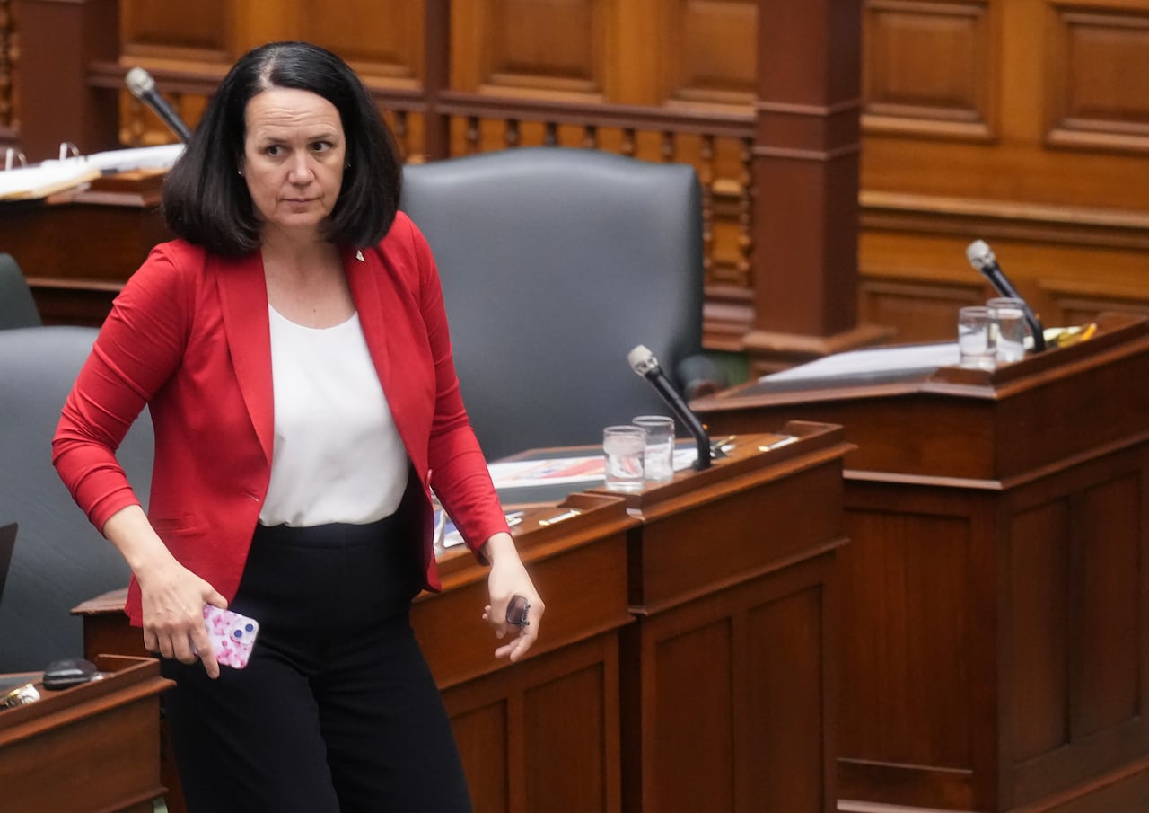Ontario Liberal MPP Lee Fairclough stands at Queen's Park, wearing a red blazer and white shirt.
