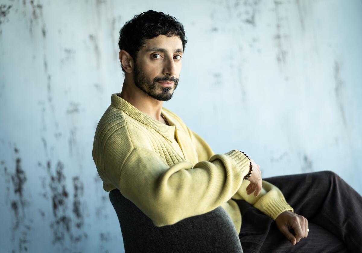 A man in a yellow top poses for the camera.