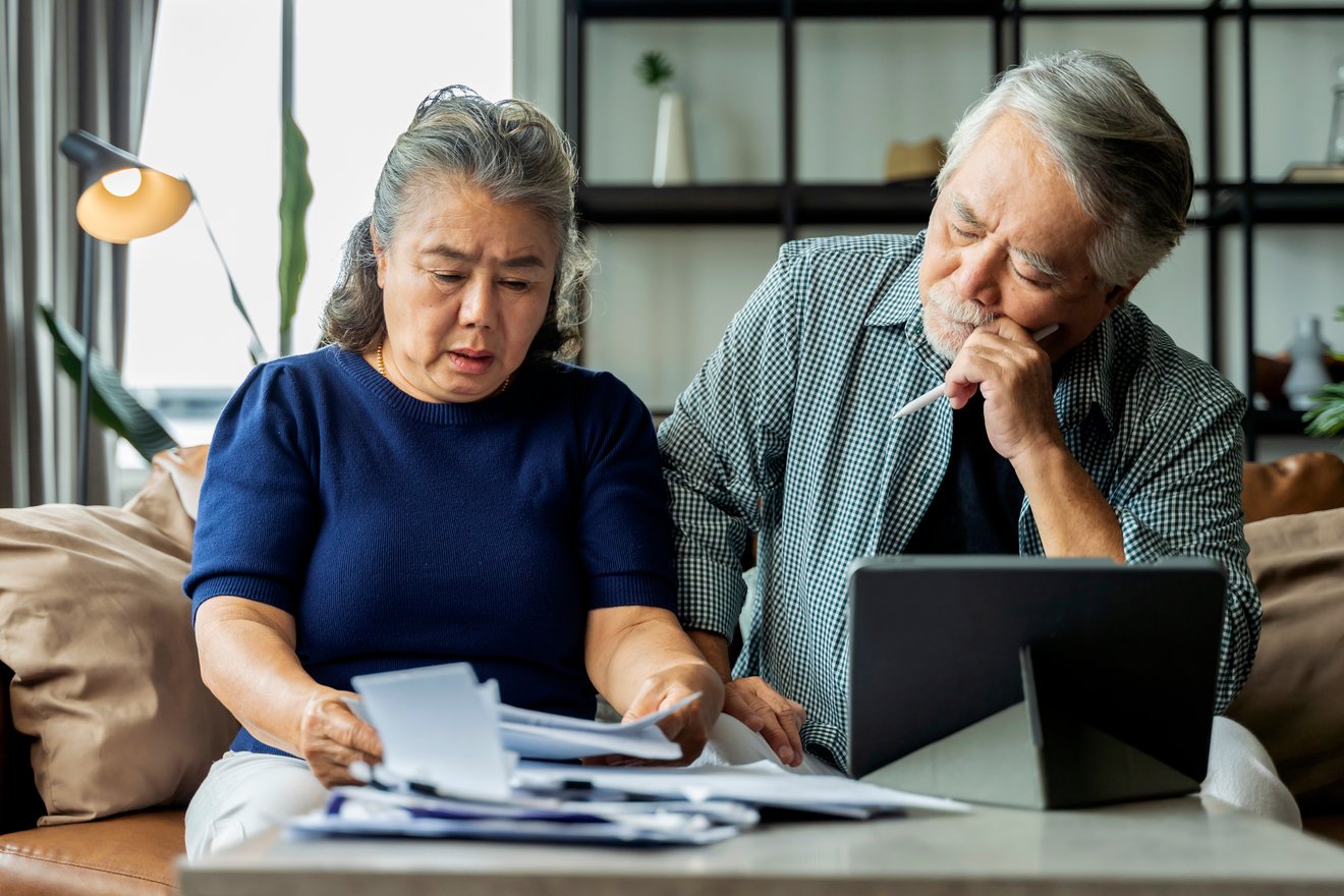 A stressed couple looking at documents together.