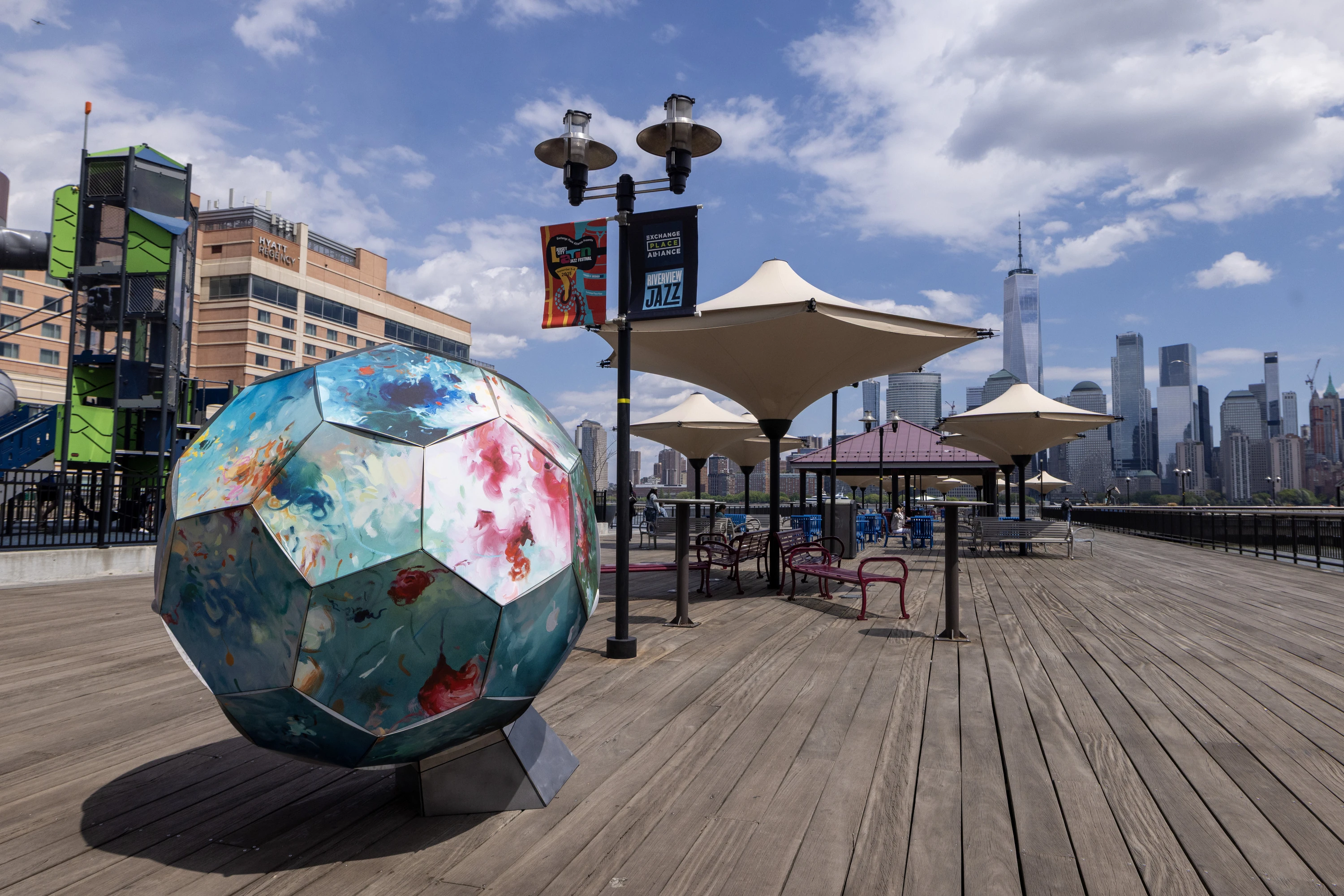 14C Artist Bassim Al Shaker and a crew of art installers place the first outdoor a soccer ball that is part of the series "Art of the Game."