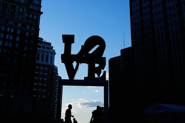 People walk past the Love Sculpture in Philadelphia, Monday, June 15, 2026. (AP Photo/Petr David Josek)