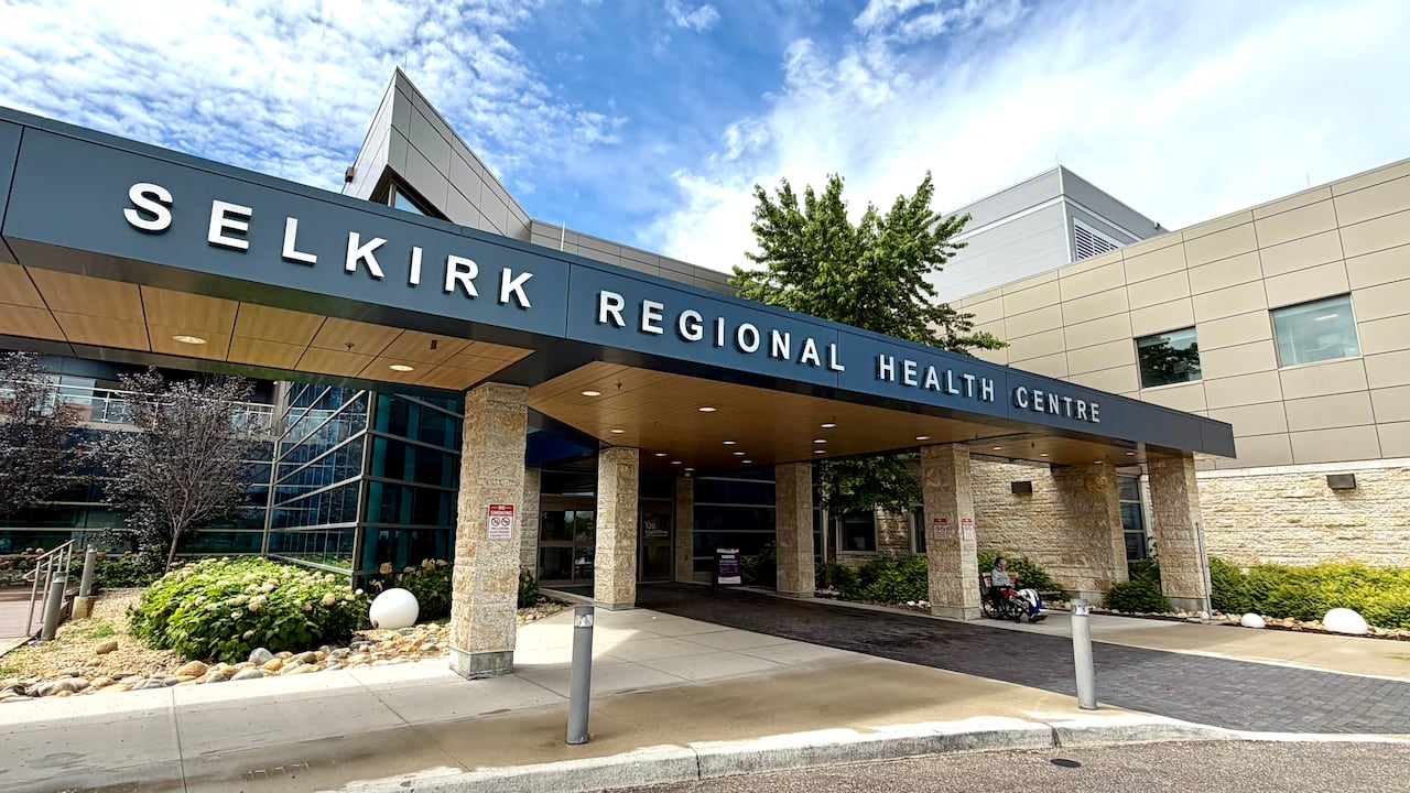 a health-care building has a navy blue sign above the entrance that reads "Selkirk Regional Health Centre."