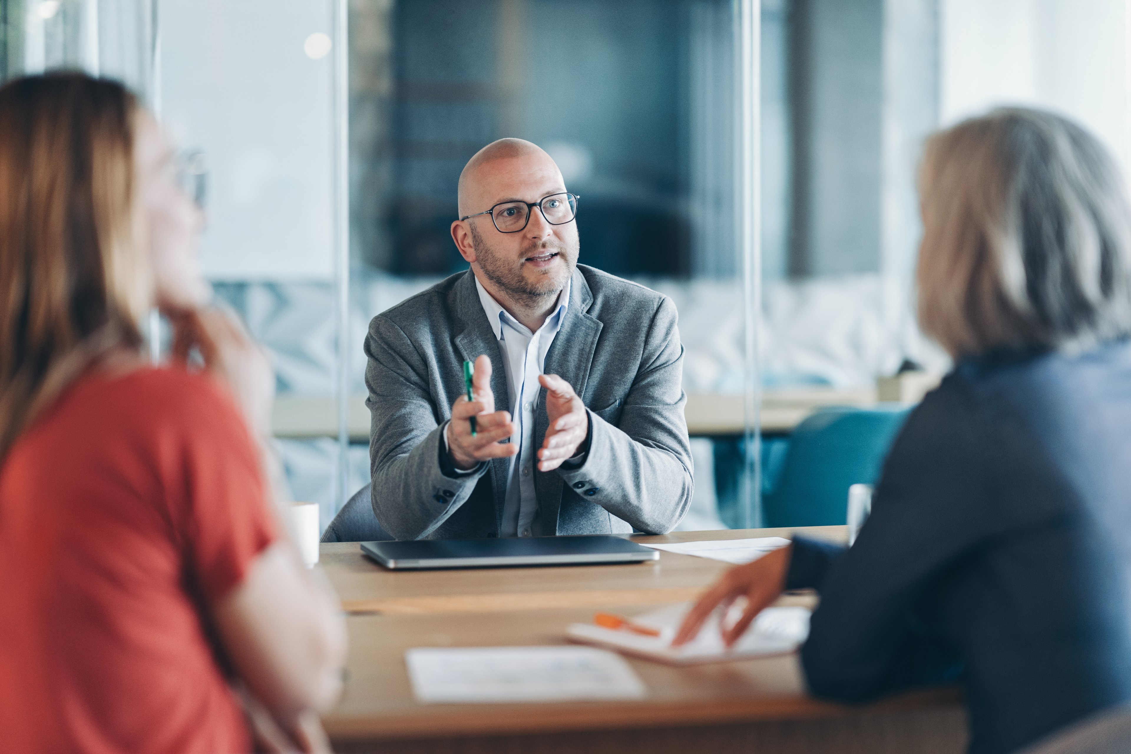 Two clients sitting in a conversation with a financial advisor.