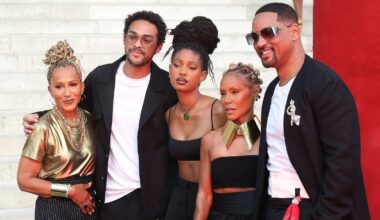 Will Smith and Jada Pinkett Smith pose in coordinated looks with Willow and Trey Smith to support Jaden Smith at Paris Fashion Week