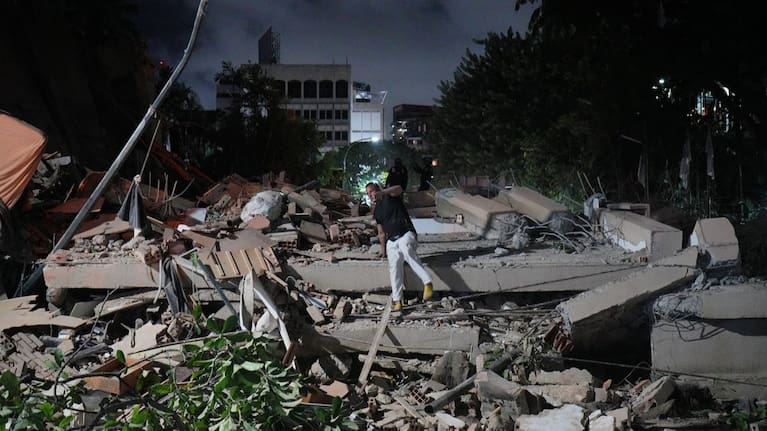 A man jumps on a collapsed building after an earthquake in Caracas, Venezuela.