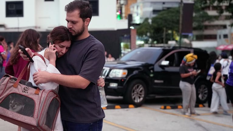 People embrace after an earthquake in Caracas, Venezuela.