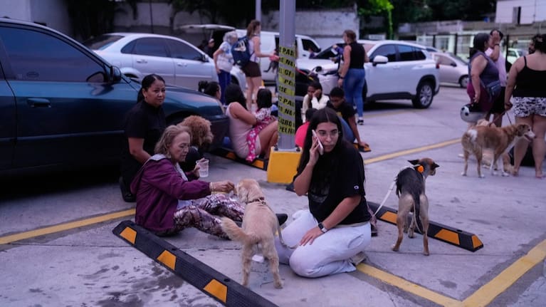 People stay outside their homes after an earthquake in Caracas, Venezuela.