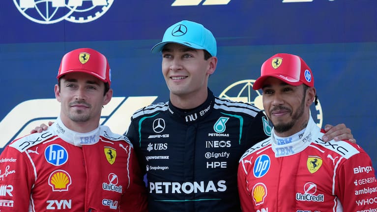 George Russell (middle) celebrates pole after narrowly beating Charles Leclerc (left).