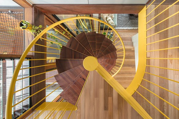 An open spiral staircase connects the public areas to the bedrooms on the upper floor.